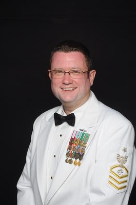 Navy dress whites formal portrait with bow tie and service ribbons