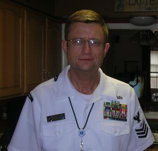 Don Sawyer in Navy dress white uniform with Senior Chief Petty Officer insignia and service ribbons