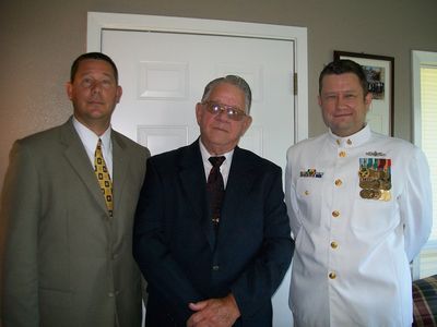 Family photo with Navy personnel in dress whites
