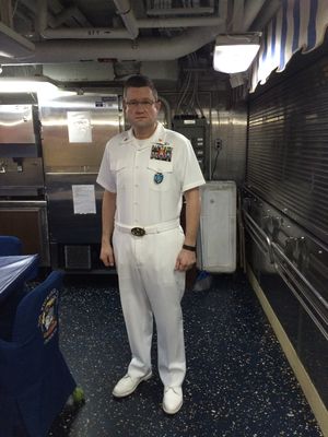 Don Sawyer in dress whites aboard ship corridor