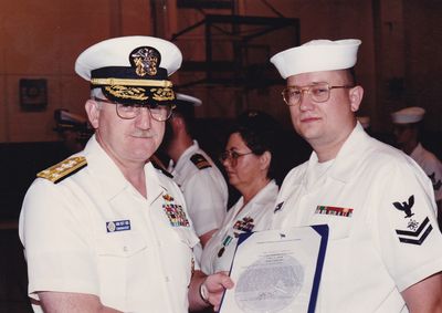 A senior officer presenting an award during a formal ceremony