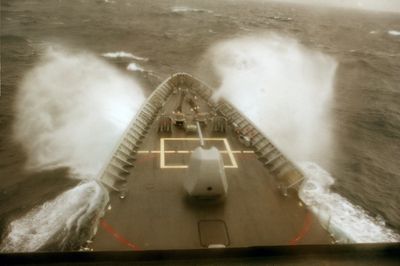 Ship's bow cutting through heavy seas