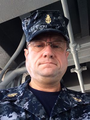 Portrait in working uniform aboard ship