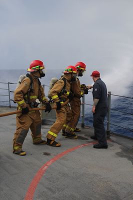 Damage control team conducting a firefighting drill on deck