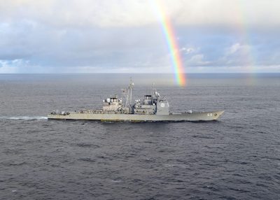 USS Vicksburg (CG-69) underway at sea with a rainbow in the sky