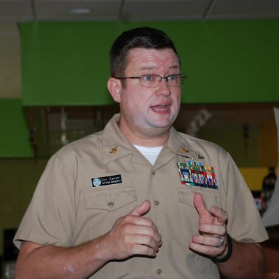 Officer briefing the room in a working uniform