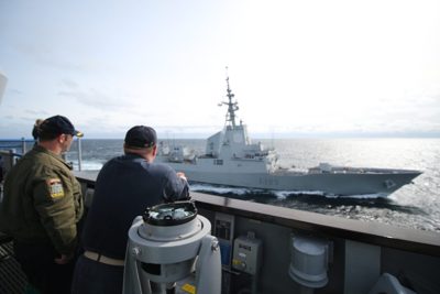 Two Sailors watching the horizon from the ship's bridge