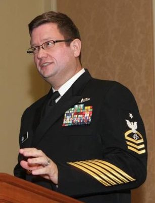 Chief speaking to the crew in dress uniform