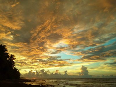 Golden hour sunset out past the horizon at sea